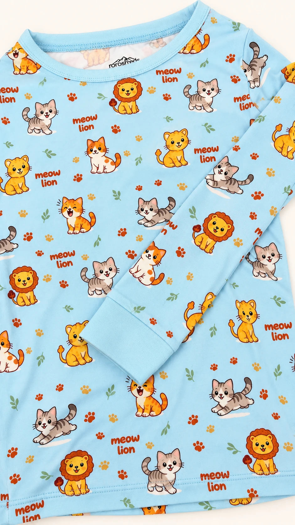 Meow Lion pajama top with a long sleeve, aqua cuff and stitched hem
